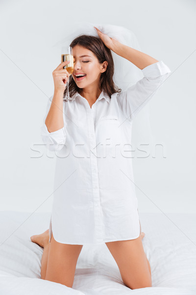 Happy women wearing bridal veil and holding glass with champagne Stock photo © deandrobot