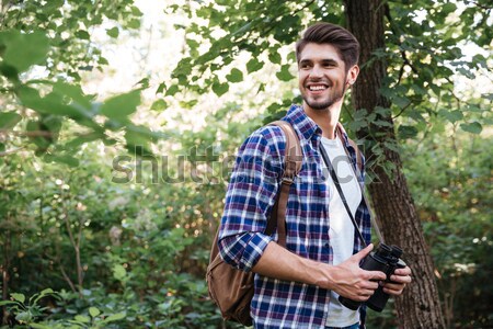 Yandan görünüş adam sırt çantası orman gülen gömlek Stok fotoğraf © deandrobot