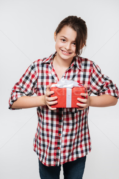 Happy young girl posing with gift Stock photo © deandrobot