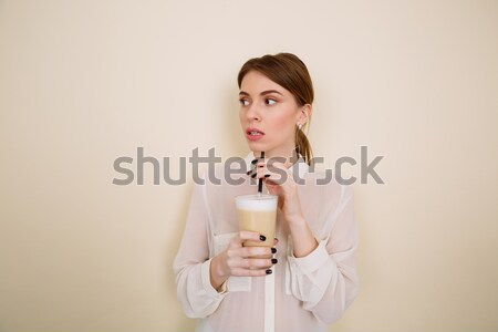 Dalgın güzel genç kadın ayakta içme kahve Stok fotoğraf © deandrobot