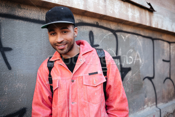 Portrait souriant africaine Guy cap sac à dos [[stock_photo]] © deandrobot