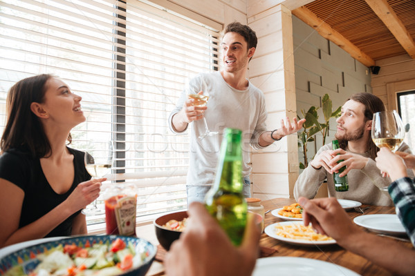 Stock photo: Group of happy people drinking and celebrating at the table