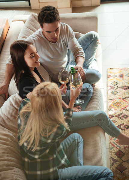 Stock photo: Top view of a cheerful young friends with wine glasses