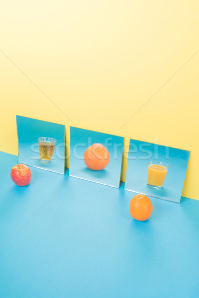 Fruits on blue table isolated over yellow background Stock photo © deandrobot