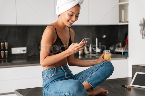 Smiling asian woman with bath towel wrapped around her head Stock photo © deandrobot