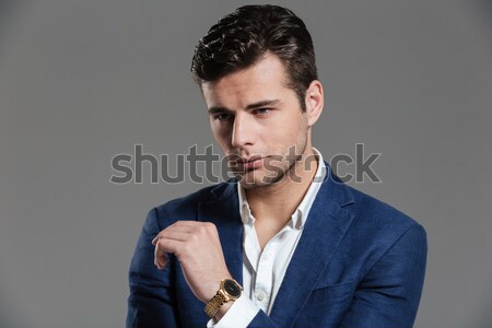 Portrait élégant jeune homme veste posant permanent [[stock_photo]] © deandrobot