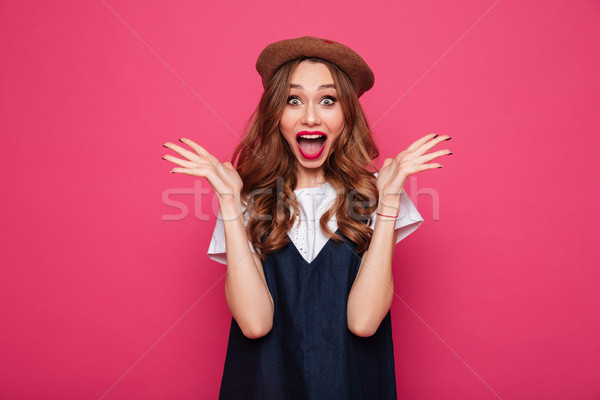 Stock photo: Excited beautiful lady looking camera with opened mouth isolated