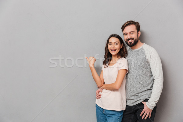 Portrait of a satisfied young couple Stock photo © deandrobot