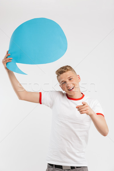 Photo of caucasian hipster boy holding blank thought bubble abov Stock photo © deandrobot