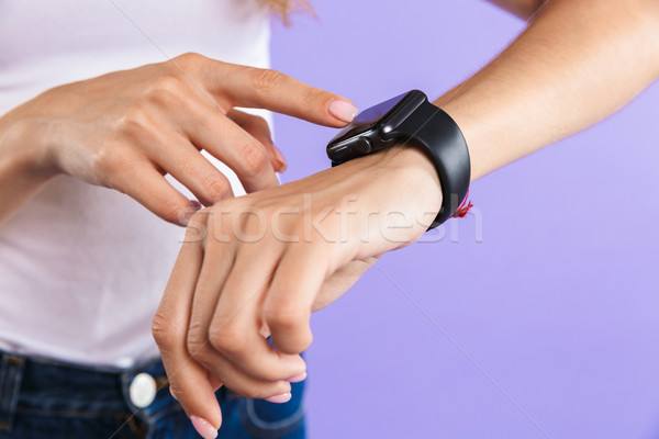 Close up of a girl touching her smartwatch Stock photo © deandrobot