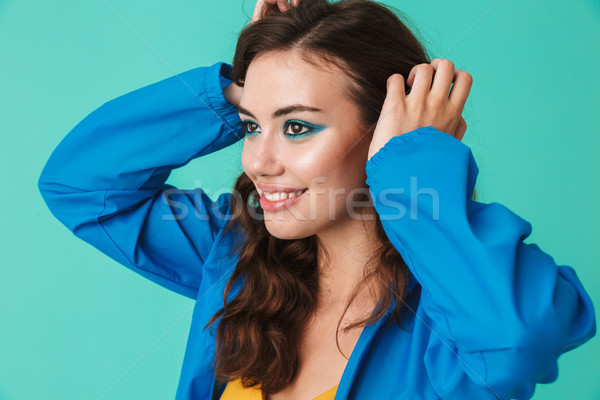 Photo of european cheerful woman 20s wearing raincoat or jacket  Stock photo © deandrobot