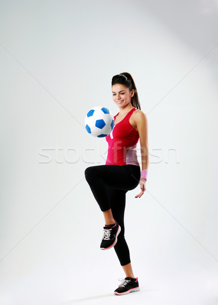 Jonge gelukkig vrouw spelen voetbal grijs Stockfoto © deandrobot