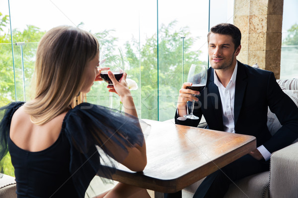 Woman and confident man drinking red wine in restaurant Stock photo © deandrobot