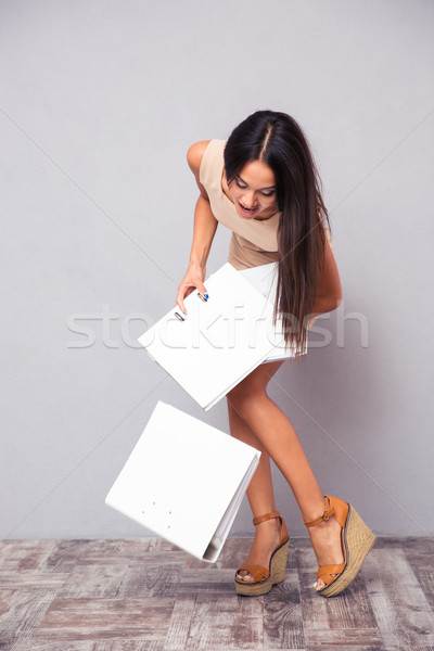 Businesswoman dropping folders on the floor Stock photo © deandrobot