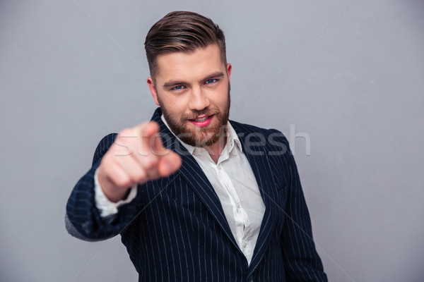 Stock photo: Handsome businessman pointing finger at camera