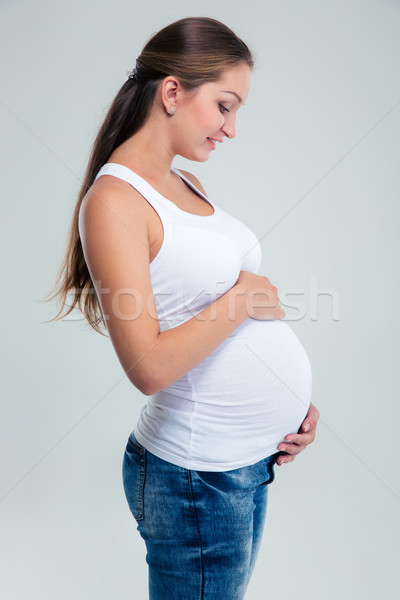 Pregnant woman caressing her belly Stock photo © deandrobot