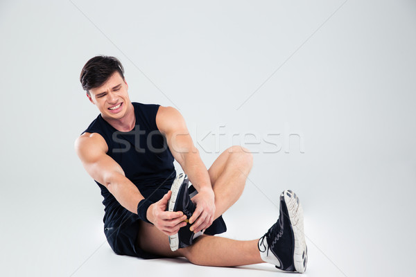 Hombre sufrimiento dolor tobillo retrato Foto stock © deandrobot