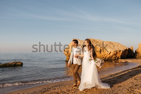 Happy just married young wedding couple celebrating Stock photo © deandrobot
