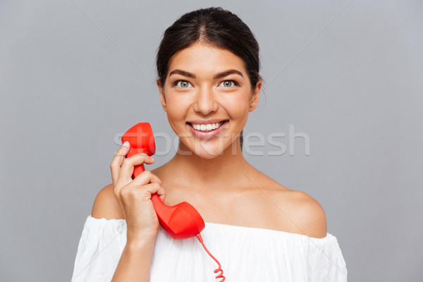 Heiter Frau sprechen Telefon Rohr schauen Stock foto © deandrobot