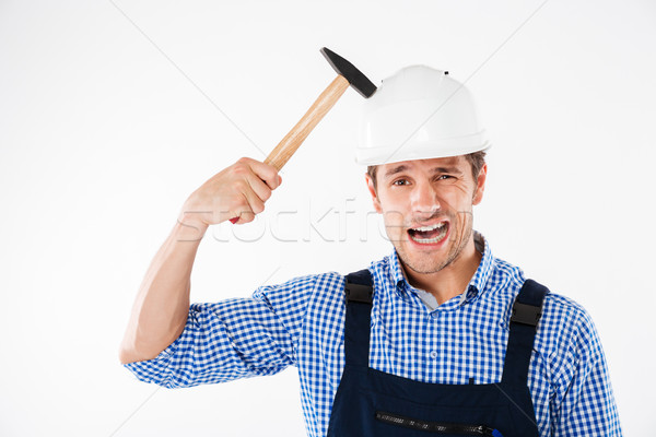 Builder applying hummer to his head in helmet Stock photo © deandrobot