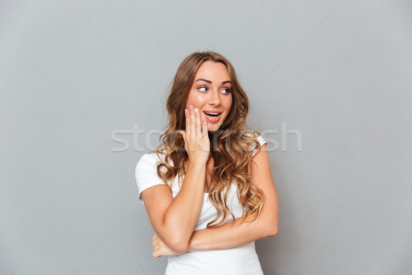 Portrait of happy surprised young woman with opened mouth Stock photo © deandrobot