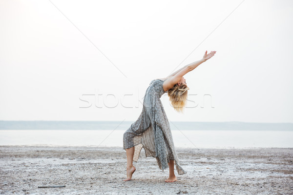 Stock photo: Woman in dress dancing on the beach