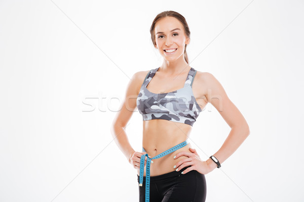 Young woman with measuring tape Stock photo © deandrobot