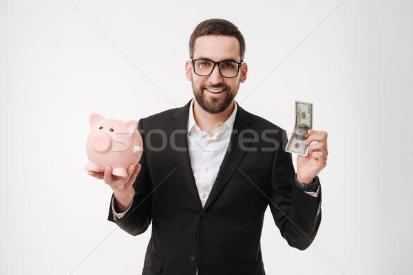 Businessman showing money and holding moneybox. Stock photo © deandrobot
