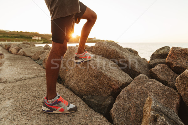 Cropped image of legs of sportsman which standing outdoors Stock photo © deandrobot