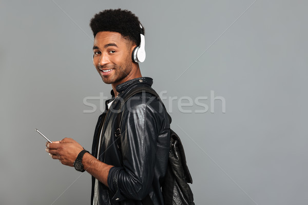 Portrait of a smiling afro american man with backpack Stock photo © deandrobot