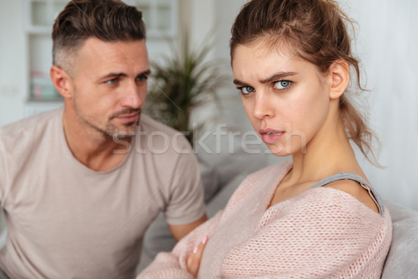 Close up image of attentive man sitting on couch Stock photo © deandrobot