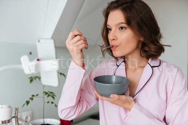 Stock photo: Portrait of a young pretty woman in pajamas