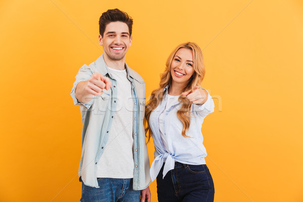 Stock photo: Photo of joyous people man and woman in basic clothing smiling a