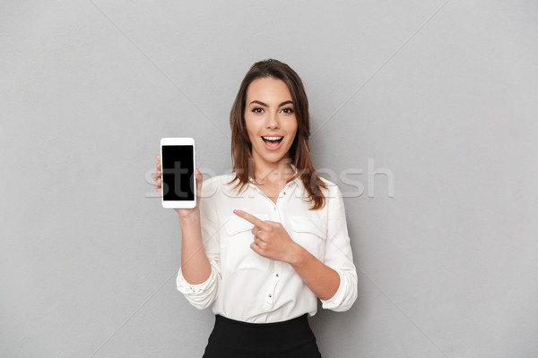 Portrait of an excited young business woman Stock photo © deandrobot