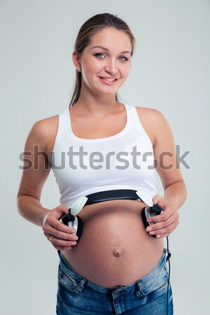 Happy pretty sporty woman showing thumb up Stock photo © deandrobot