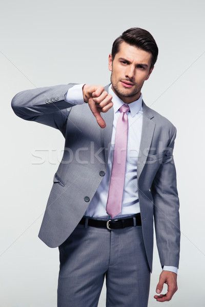 Businessman showing thumb down sign Stock photo © deandrobot