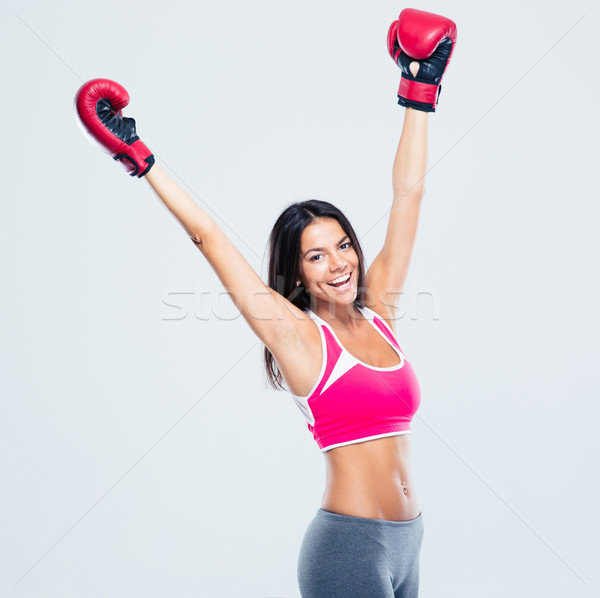 Woman in boxing gloves celebrating her success Stock photo © deandrobot