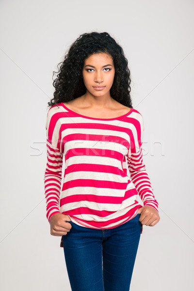 Afro american woman standing with hands in pocket Stock photo © deandrobot
