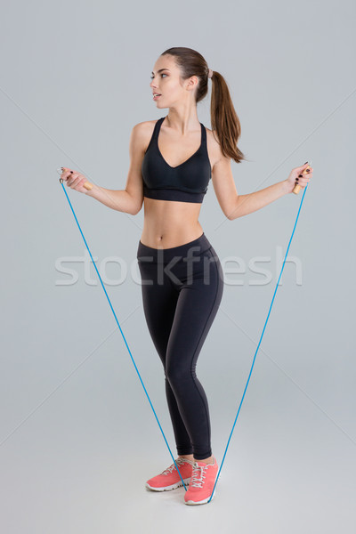 Thoughtful pretty fitness girl training with jumping rope Stock photo © deandrobot