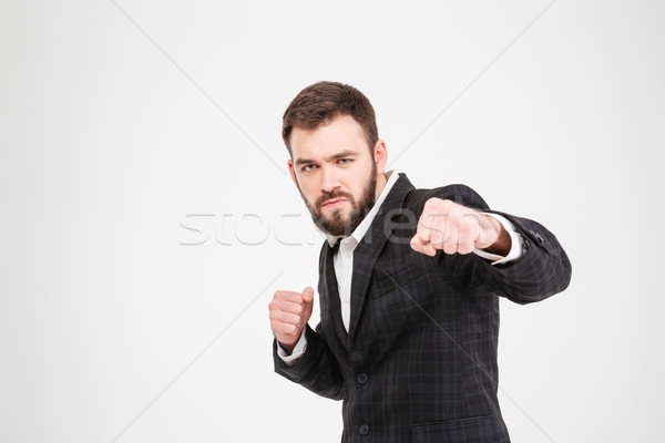 Stock photo: Businessman hitting at camera