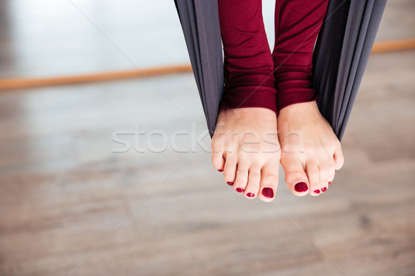 Legs of woman on hammock doing aerial yoga  Stock photo © deandrobot