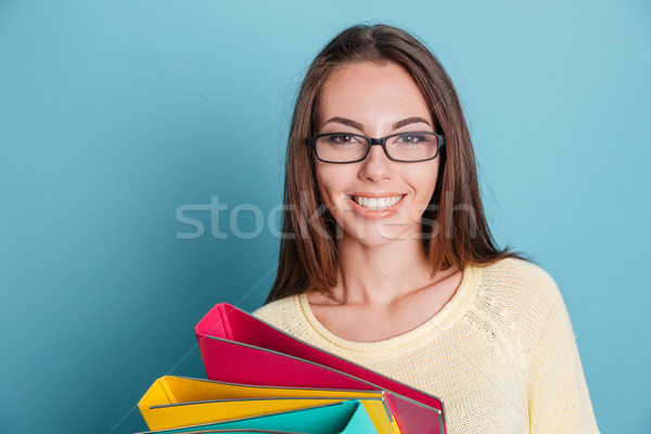Close-up portrait of smiling girl with colorful binders Stock photo © deandrobot