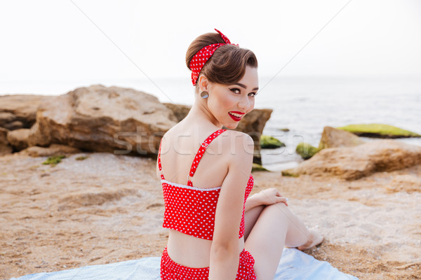 Beautiful pin up girl sitting at the beach Stock photo © deandrobot