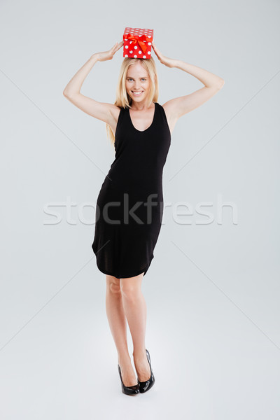Full length portrait of woman with gift box on head Stock photo © deandrobot