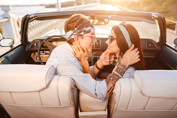 Happy couple sitting and kissing in cabriolet in summer Stock photo © deandrobot