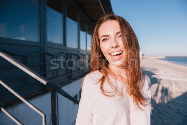 Happy Woman in sweater near the sea Stock photo © deandrobot