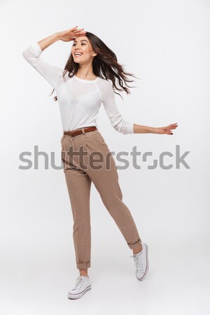 Full length of surprised cute young woman with brush jumping Stock photo © deandrobot