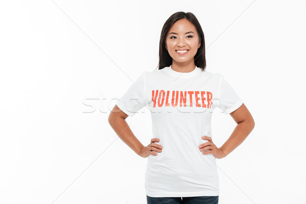 Portrait of a happy cheerful asian woman in volunteer t-shirt Stock photo © deandrobot