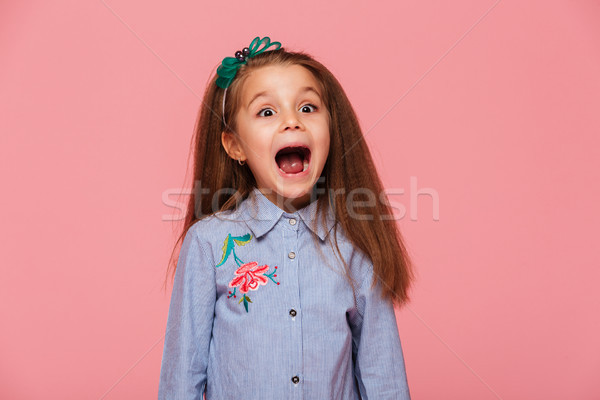 Joyous female kid in trendy shirt having fun shouting being exci Stock photo © deandrobot