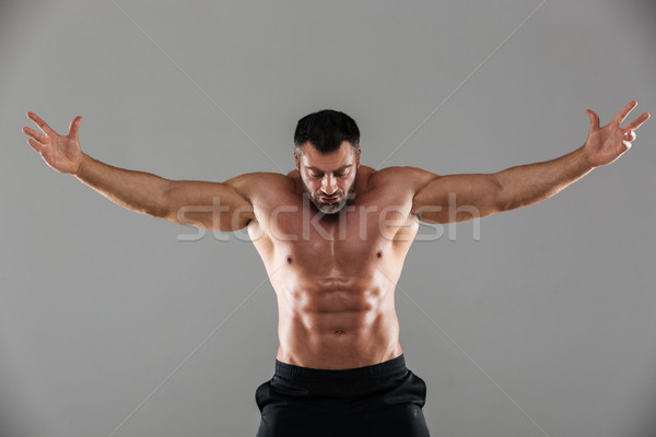 Portrait of a concentrated strong shirtless male bodybuilder Stock photo © deandrobot